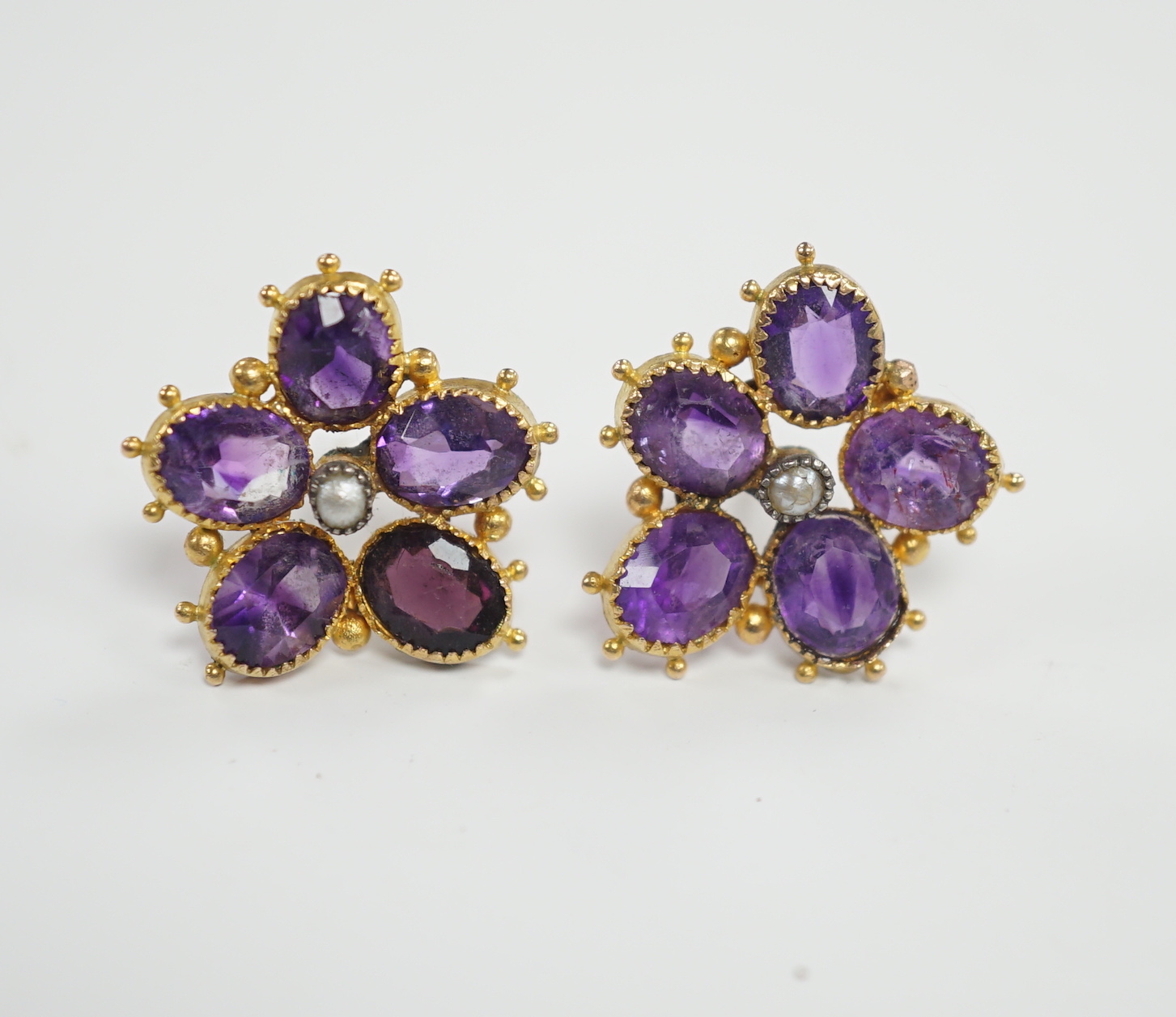 A pair of yellow metal, amethyst and seed pearl set flowerhead ear studs, 18mm, gross weight 4 grams.